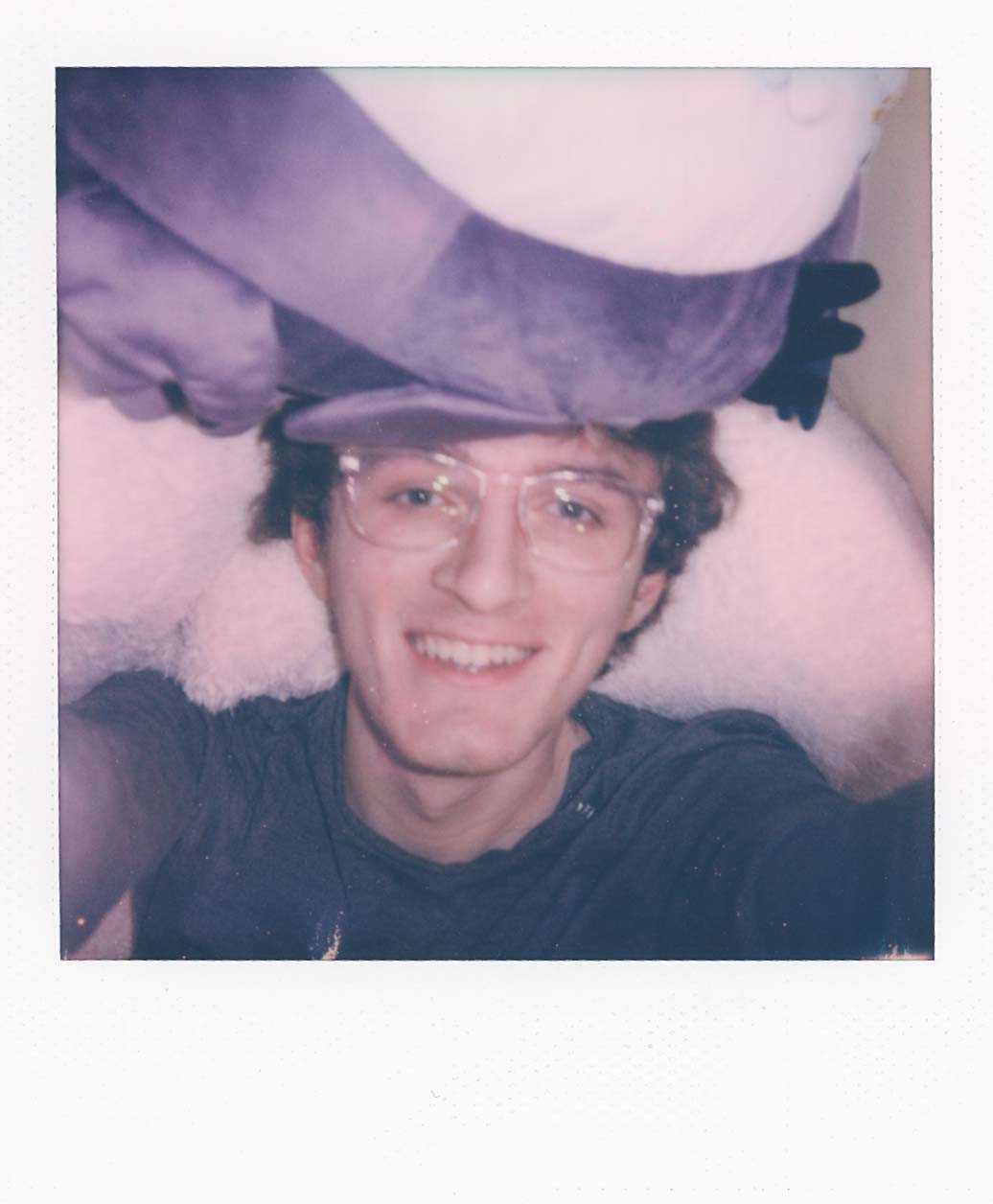 Self portrait taken from above. A plush is falling onto my face.